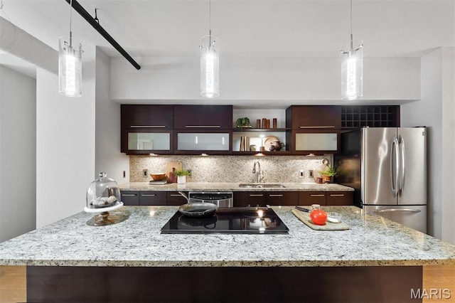 915 Olive St Unit 910, Saint Louis, MO 63101 - kitchen with appliances with stainless steel finishes, backsplash, and dark brown cabinets