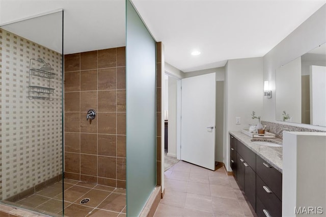 915 Olive St Unit 910, Saint Louis, MO 63101 - bathroom with a tile shower, double vanity, and tile patterned floors