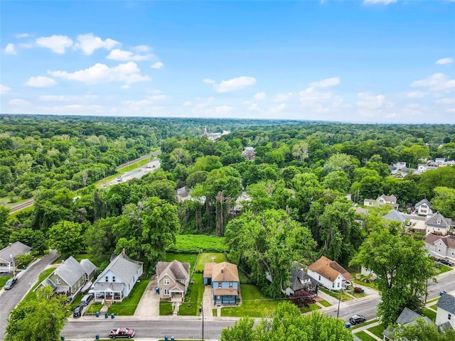 aerial view of residential area featuring a forest