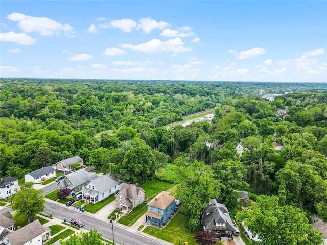 aerial perspective of suburban area featuring a heavily wooded area