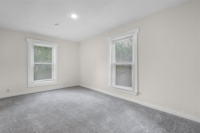 carpeted empty room featuring baseboards and recessed lighting