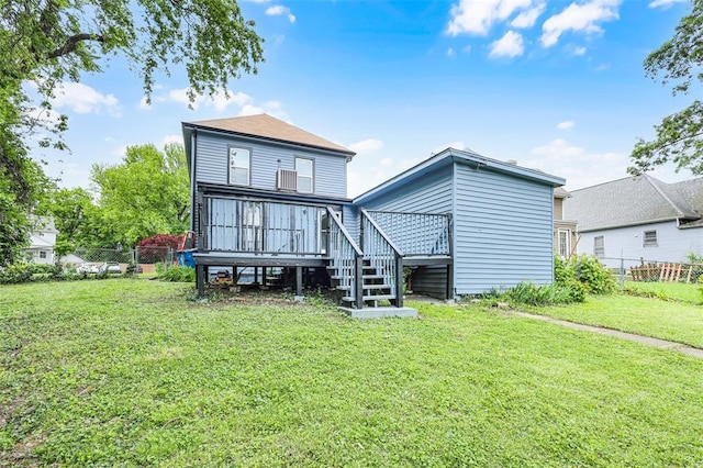 rear view of house with stairs and a deck
