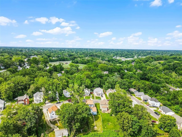aerial perspective of suburban area featuring a heavily wooded area