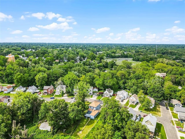 aerial view of residential area featuring a heavily wooded area