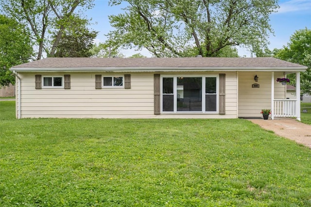 rear view of house featuring a yard