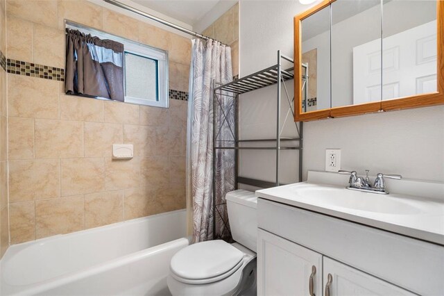 bathroom with toilet, vanity, and shower / tub combo with curtain