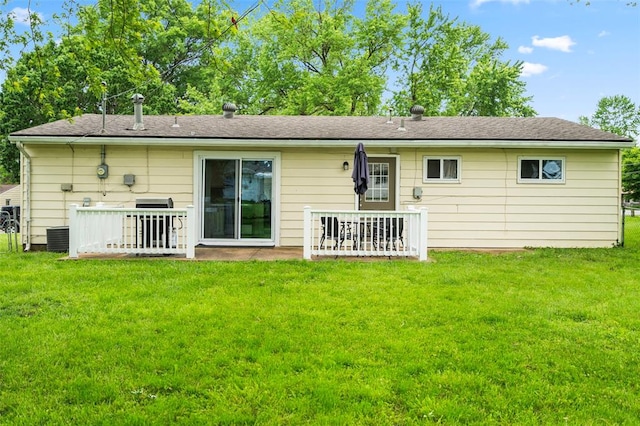 back of house featuring a yard and central AC