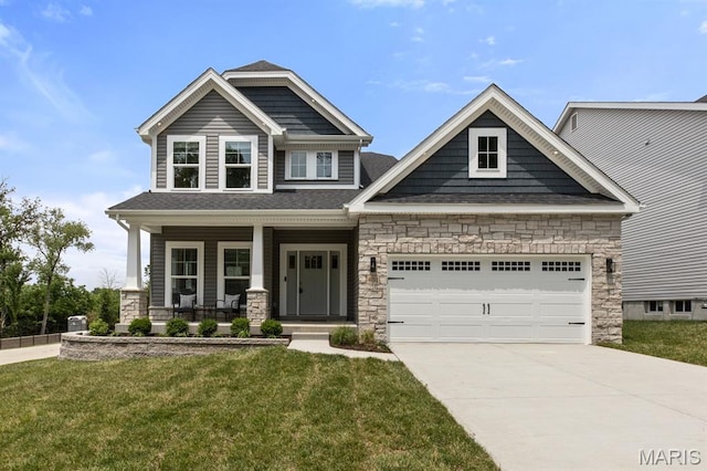 401 Rayburn Ave, Sunset Hills, MO 63127 - craftsman-style house featuring stone siding, concrete driveway, a front lawn, a garage, and covered porch
