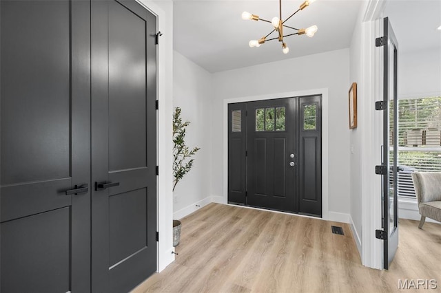 401 Rayburn Ave, Sunset Hills, MO 63127 - entryway featuring baseboards, a chandelier, and light wood-style flooring