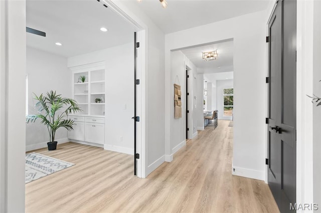 401 Rayburn Ave, Sunset Hills, MO 63127 - hall with light wood finished floors, baseboards, and built in shelves