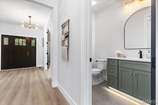 401 Rayburn Ave, Sunset Hills, MO 63127 - entrance foyer featuring a chandelier, baseboards, and light wood-type flooring