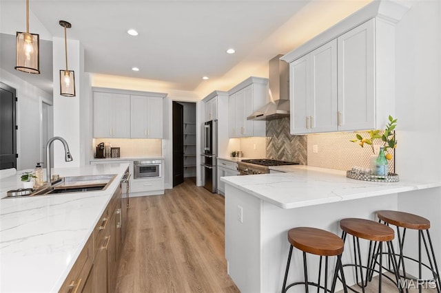 401 Rayburn Ave, Sunset Hills, MO 63127 - kitchen with wall chimney exhaust hood, a sink, a peninsula, light stone countertops, and range