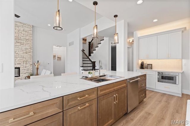401 Rayburn Ave, Sunset Hills, MO 63127 - kitchen with a sink, stainless steel dishwasher, light wood-type flooring, white cabinets, and recessed lighting