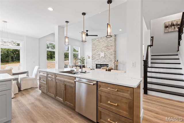 401 Rayburn Ave, Sunset Hills, MO 63127 - kitchen featuring dishwasher, a sink, ceiling fan, light wood-style flooring, and a stone fireplace