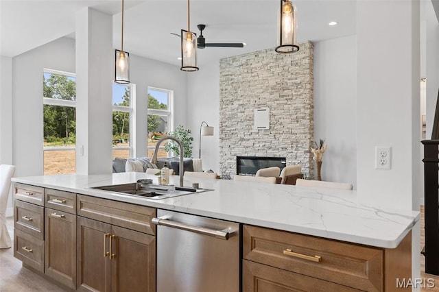 401 Rayburn Ave, Sunset Hills, MO 63127 - kitchen featuring dishwasher, a sink, open floor plan, ceiling fan, and a fireplace
