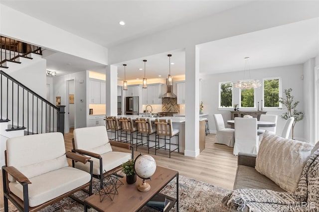 401 Rayburn Ave, Sunset Hills, MO 63127 - living room featuring stairs, light wood-type flooring, recessed lighting, a chandelier, and baseboards