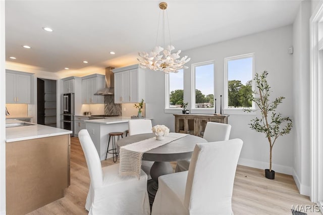 401 Rayburn Ave, Sunset Hills, MO 63127 - dining room featuring a chandelier, recessed lighting, light wood-style flooring, and baseboards