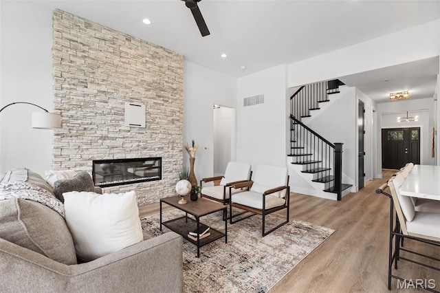 401 Rayburn Ave, Sunset Hills, MO 63127 - living area with stairway, a ceiling fan, light wood-style floors, a fireplace, and recessed lighting