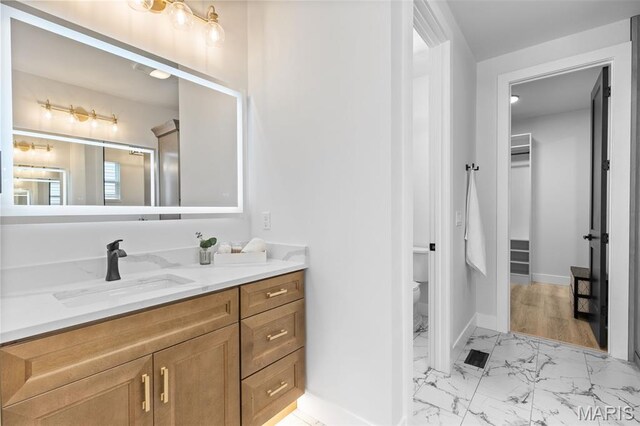 401 Rayburn Ave, Sunset Hills, MO 63127 - bathroom featuring vanity, marble finish floors, toilet, and baseboards