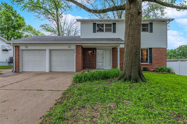 traditional-style home featuring a garage, concrete driveway, and brick siding