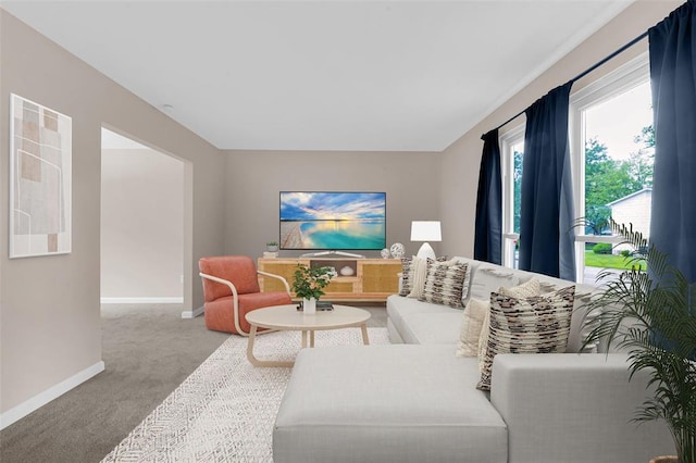 carpeted living room featuring baseboards