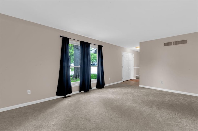 carpeted spare room with baseboards