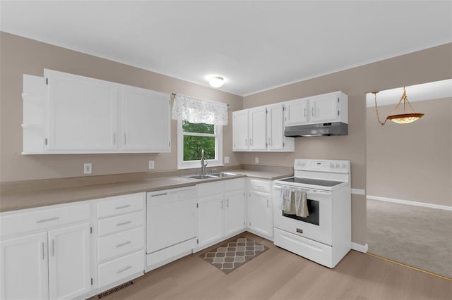 kitchen featuring white appliances, a sink, under cabinet range hood, white cabinets, and crown molding