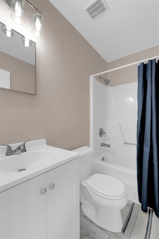 full bathroom featuring toilet, marble look tile flooring, vanity, and shower / tub combo with curtain