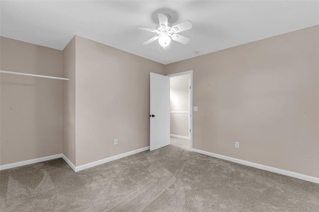 unfurnished bedroom with carpet floors, baseboards, and a ceiling fan