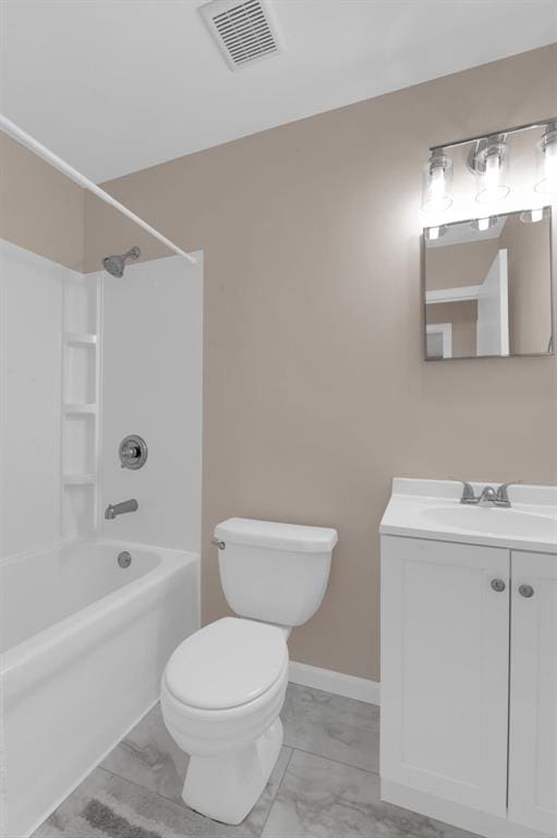 full bath featuring marble look tile flooring, washtub / shower combination, toilet, and vanity
