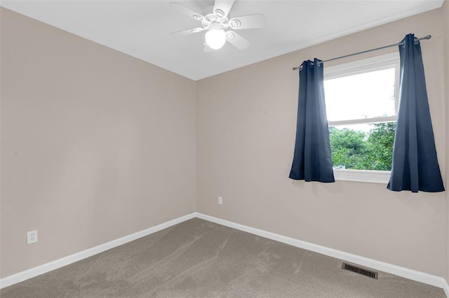 spare room with baseboards, a ceiling fan, and carpet floors