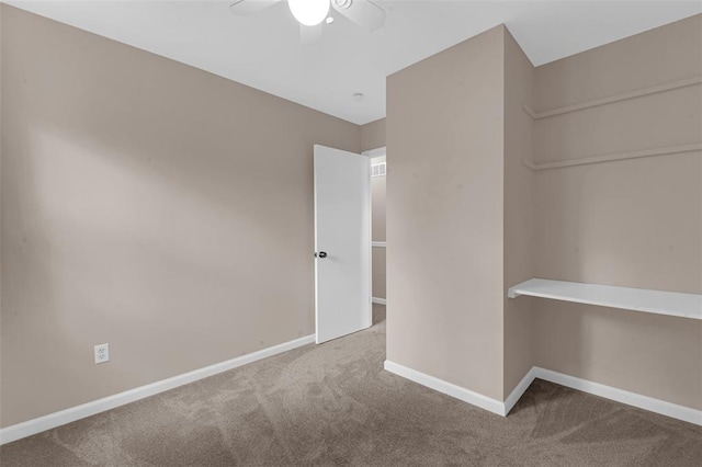 empty room featuring carpet flooring, ceiling fan, and baseboards
