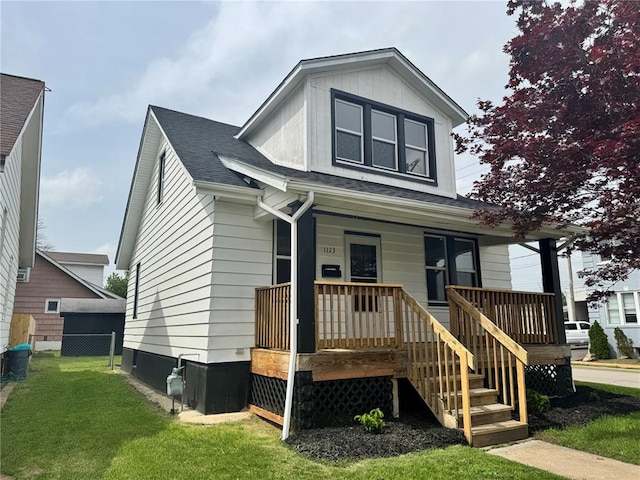 view of front of property featuring a porch and a shingled roof