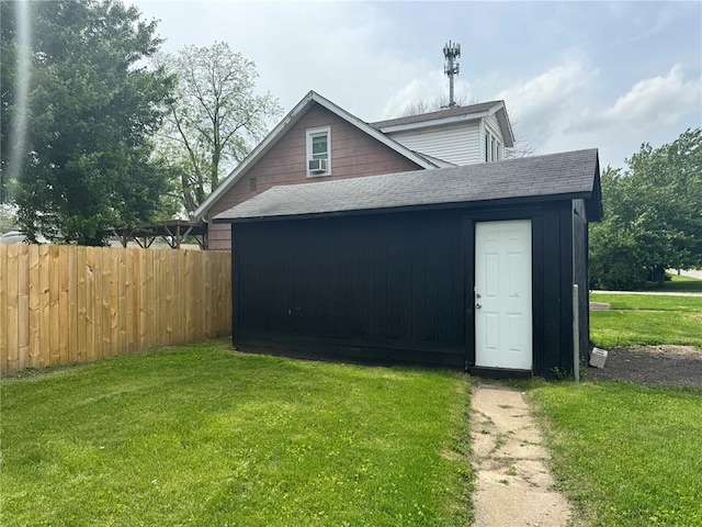 view of property exterior with roof with shingles and an outdoor structure