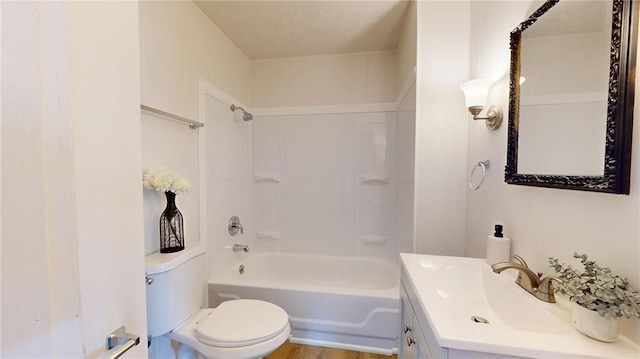 bathroom with toilet, vanity, and shower / washtub combination