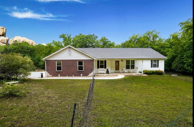 view of front of home featuring a patio area and brick siding