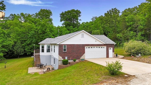 view of front of property featuring concrete driveway, a front lawn, stairs, and an attached garage