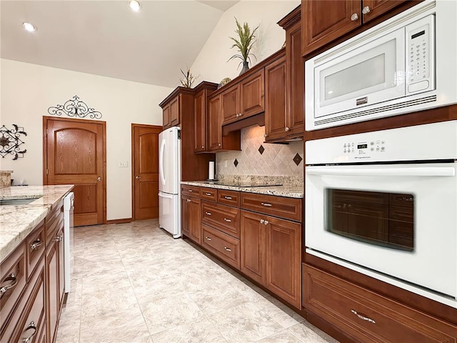 kitchen with white appliances, backsplash, lofted ceiling, light stone counters, and recessed lighting