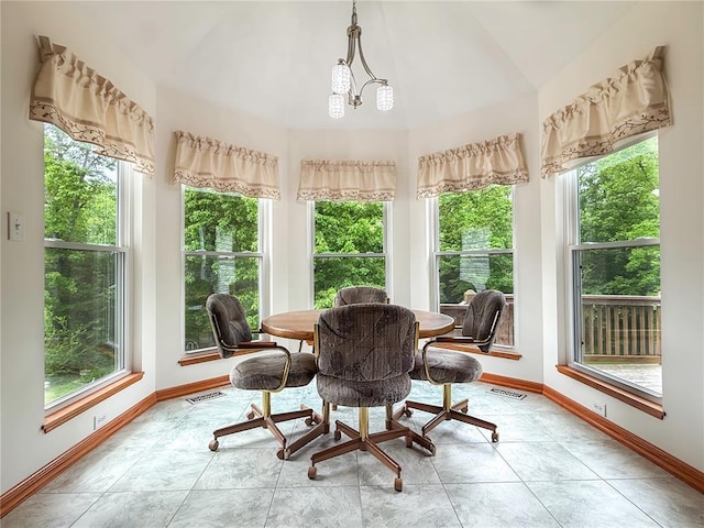 dining area featuring baseboards and vaulted ceiling