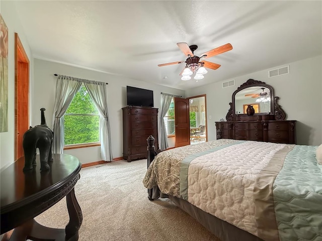 bedroom with light colored carpet, ceiling fan, and baseboards