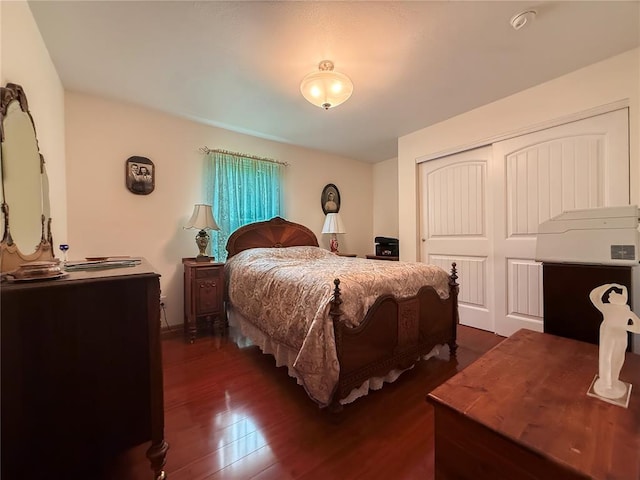 bedroom featuring a closet and dark wood finished floors