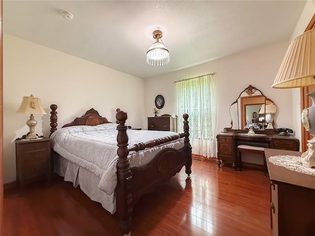 bedroom featuring dark wood finished floors