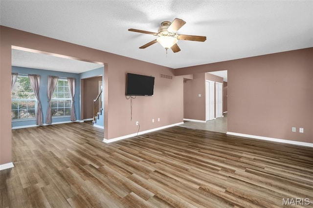 881 Sara Beth Ct, Saint Peters, MO 63376 - spare room featuring ceiling fan, wood finished floors, and stairway