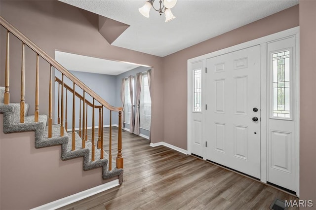 881 Sara Beth Ct, Saint Peters, MO 63376 - foyer entrance with plenty of natural light, wood finished floors, and stairway