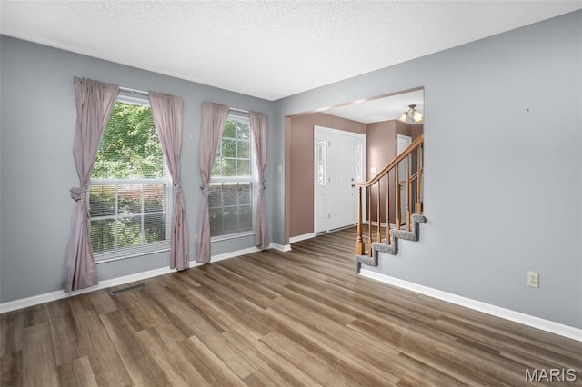 881 Sara Beth Ct, Saint Peters, MO 63376 - foyer with wood finished floors, stairs, and a textured ceiling