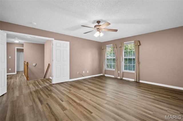 881 Sara Beth Ct, Saint Peters, MO 63376 - empty room with wood finished floors, a ceiling fan, and a textured ceiling