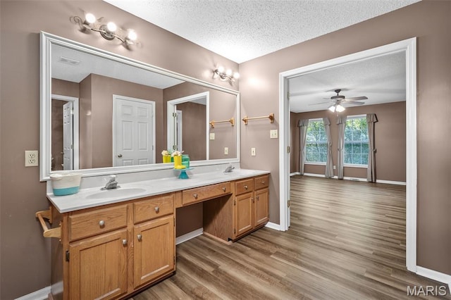 881 Sara Beth Ct, Saint Peters, MO 63376 - bathroom with a textured ceiling, double vanity, wood finished floors, and a ceiling fan