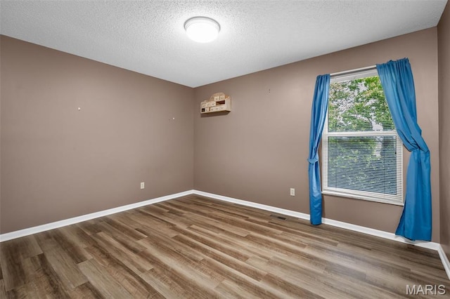 881 Sara Beth Ct, Saint Peters, MO 63376 - spare room featuring wood finished floors and a textured ceiling
