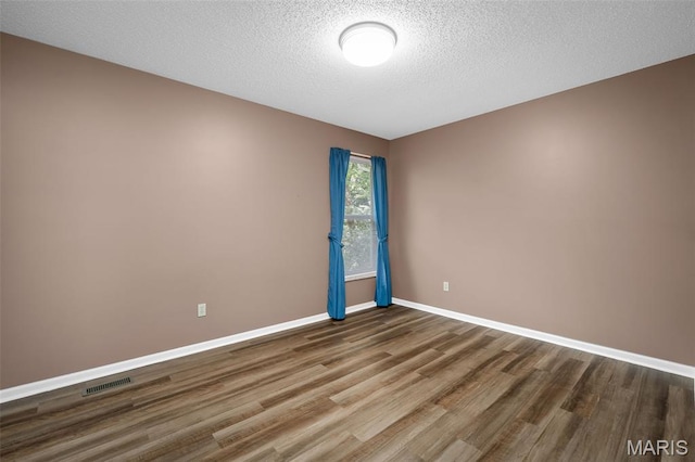 881 Sara Beth Ct, Saint Peters, MO 63376 - spare room with wood finished floors and a textured ceiling