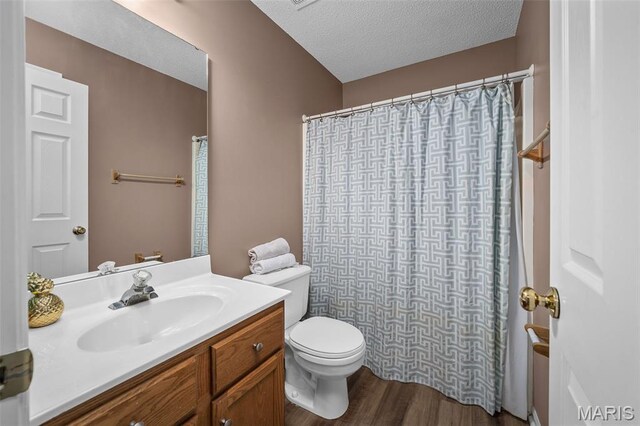 881 Sara Beth Ct, Saint Peters, MO 63376 - full bath with vanity, wood finished floors, curtained shower, and a textured ceiling